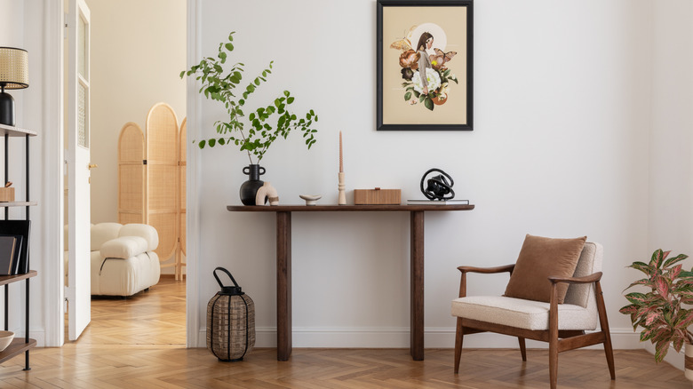 Cozy entryway with a table, chair, and wall art