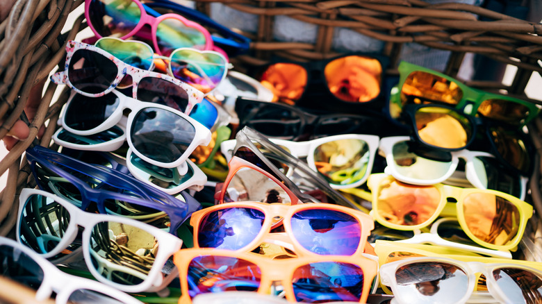Many sunglasses in a basket