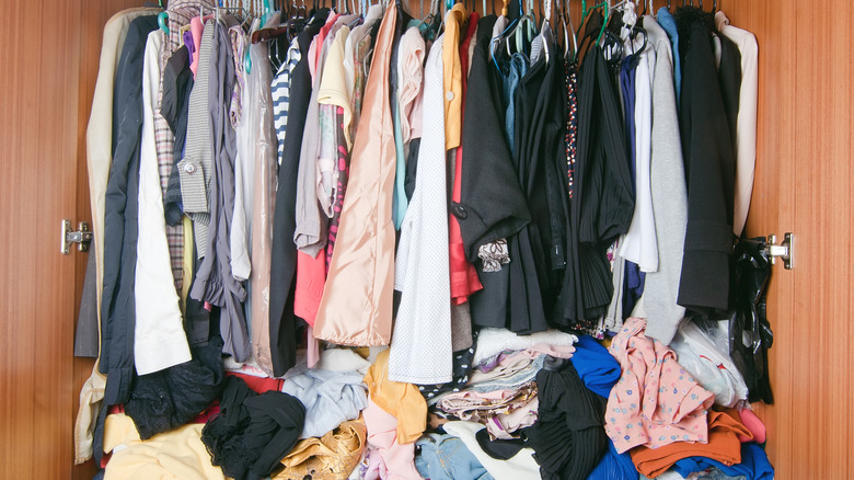messy closet with overflowing clothes