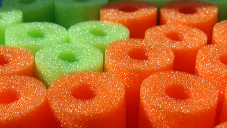 green and orange pool noodles