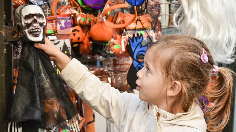 child grabbing dollar tree decoration