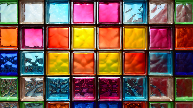A closeup of a wall with colored glass blocks