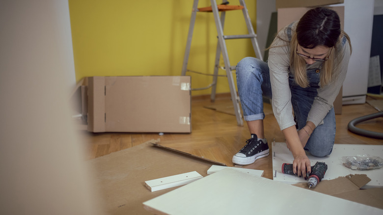 Woman assembling IKEA cabinet