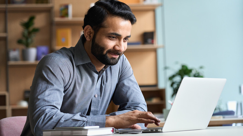 man using laptop in office