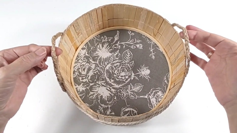 Hands holding a rustic basket