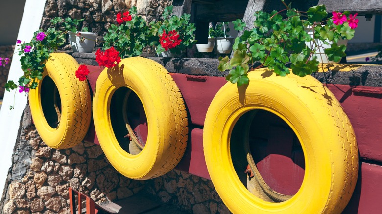 painted tire decor in backyard