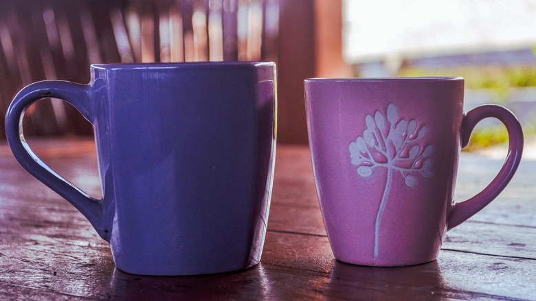 coffee mugs on wooden surface