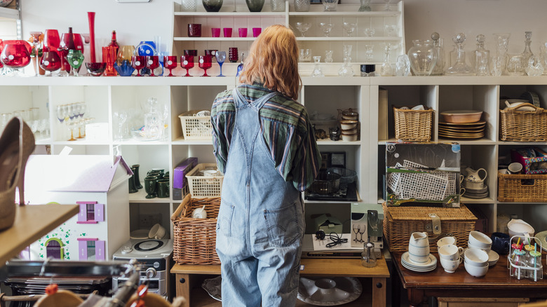 Person browsing storage containers at a thrift store