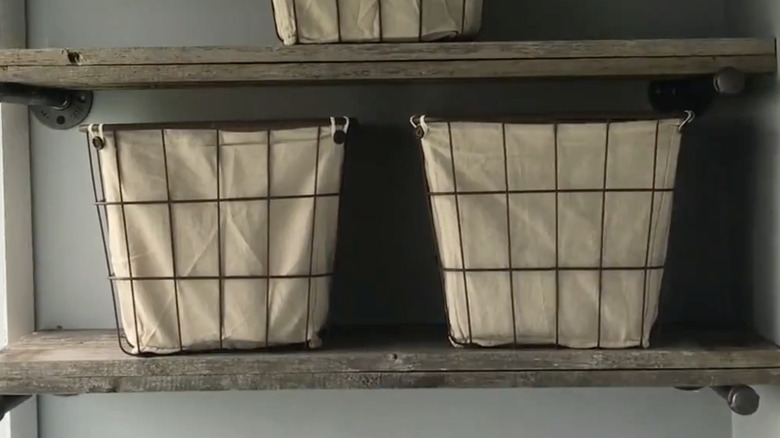 Two wooden shelves with wire baskets.