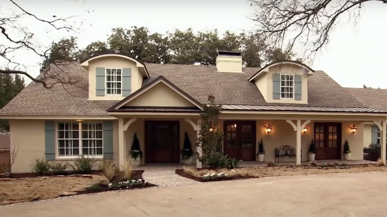 tan house with window shutters