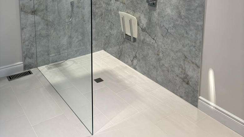 A curbless shower with a glass side and no threshold or door