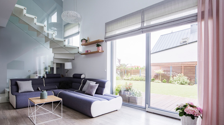 Roman folding blinds over sliding glass door in modern living room