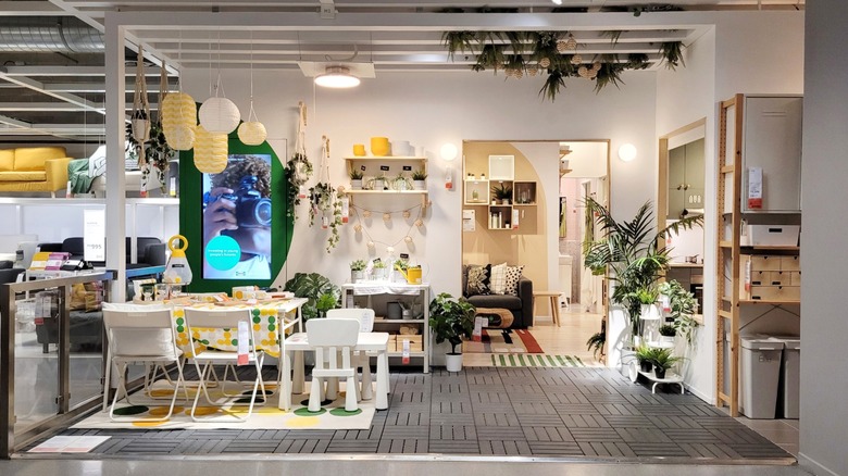 IKEA showroom furniture display area featuring biophilic and metal elements