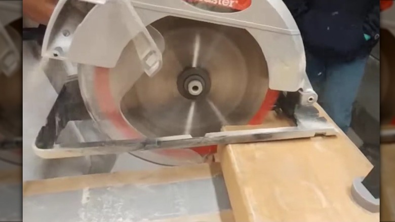 Drill Master 7.25-inch circular saw being used to cut lumber