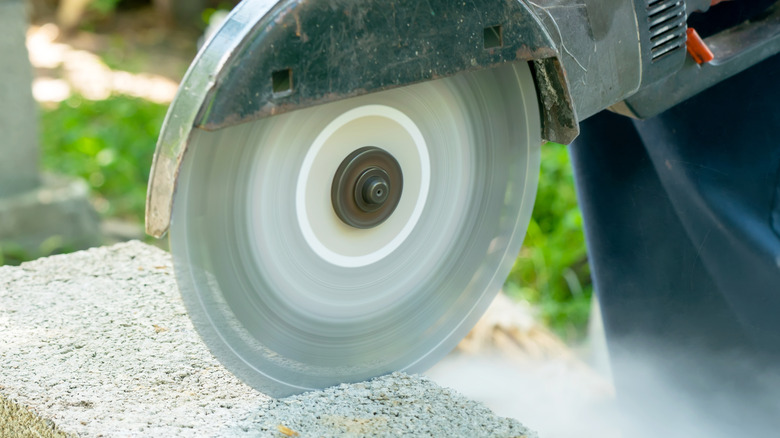 Cutting a cinder block with a heavy-duty angle grinder