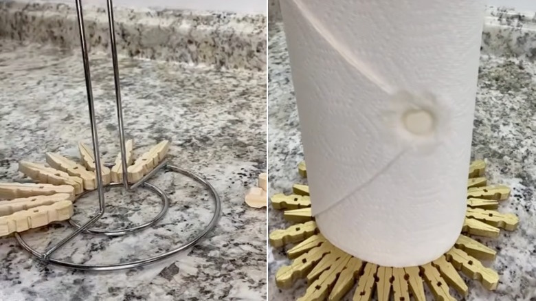 A wire paper towel holder with a few wooden clothespins stuck to the base; a base for a paper towel holder made of gold-painted clothespins