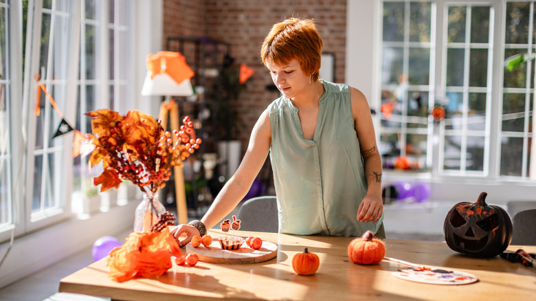 Someone standing at a fall-themed craft table