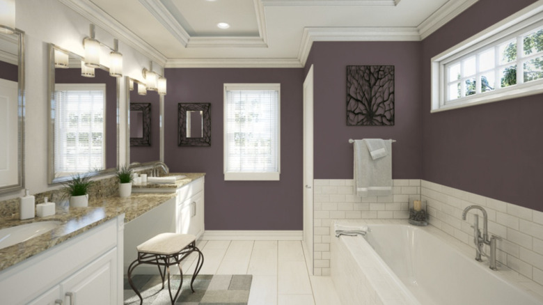 A bathroom with white tile and purple walls