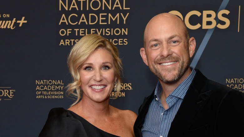 Jenny and Dave Marrs smile at a red carpet event