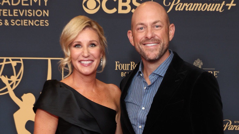 Jenny and Dave Marrs smiling at a carpet event