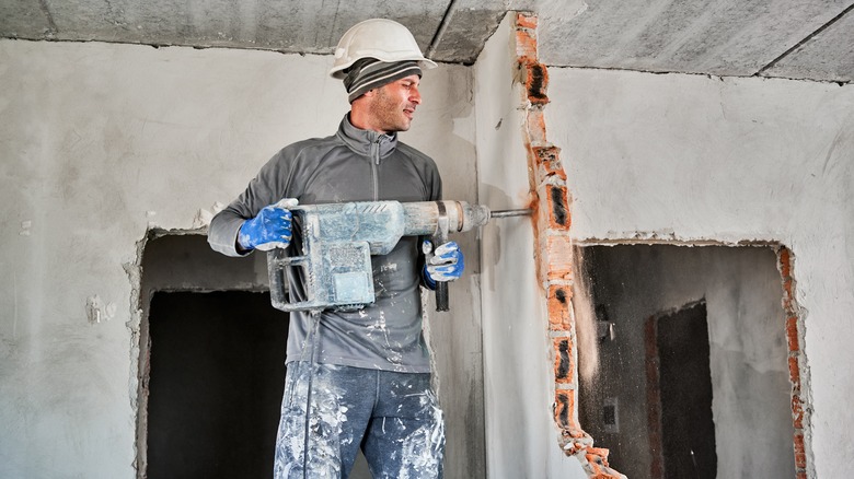 man breaking down wall