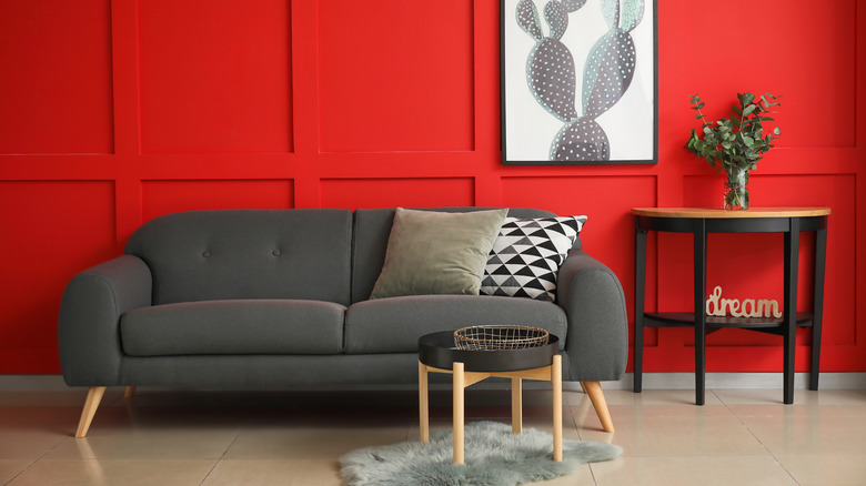 Gray sofa against bold orange wall