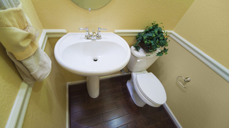 Small powder bathroom with yellow walls