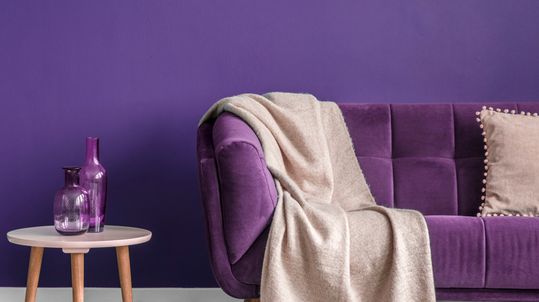 Monochromatic living room with purple walls, purple decor, and a purple couch