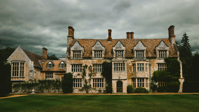 Historic manor under a cloudy sky