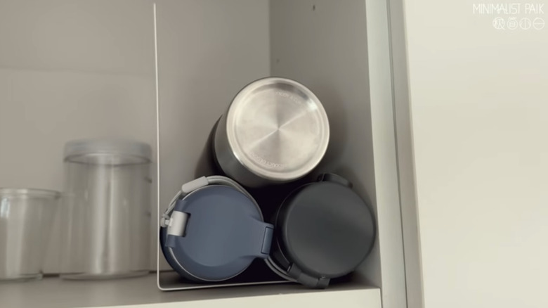 A bookend creating a corner space for 3 water bottles