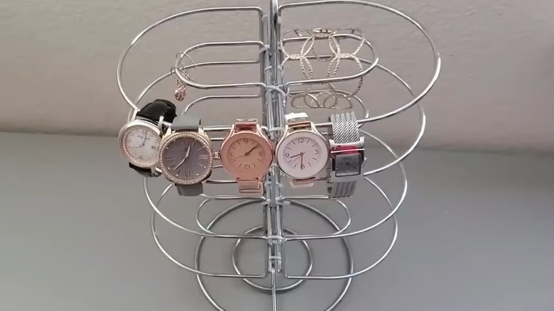 Watches, bracelets, and earrings on a jewelry tower
