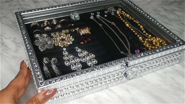 Jewelry inside a bejeweled silver display case