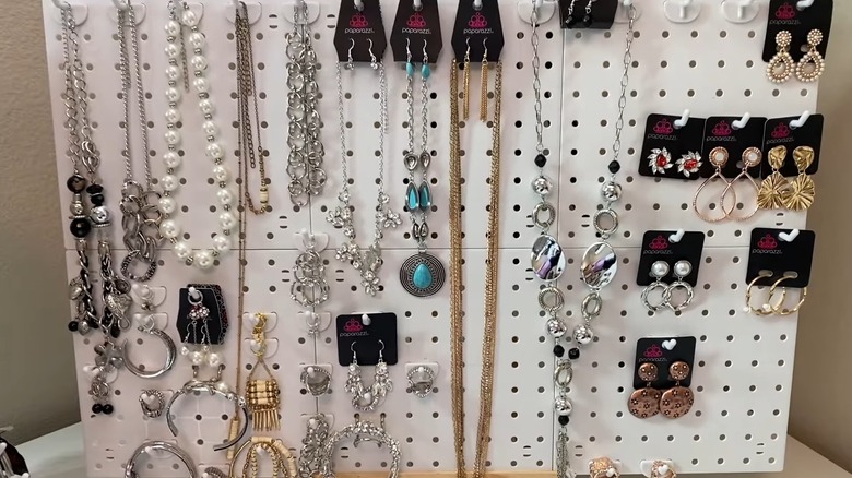 Jewelry organized on six white peg boards
