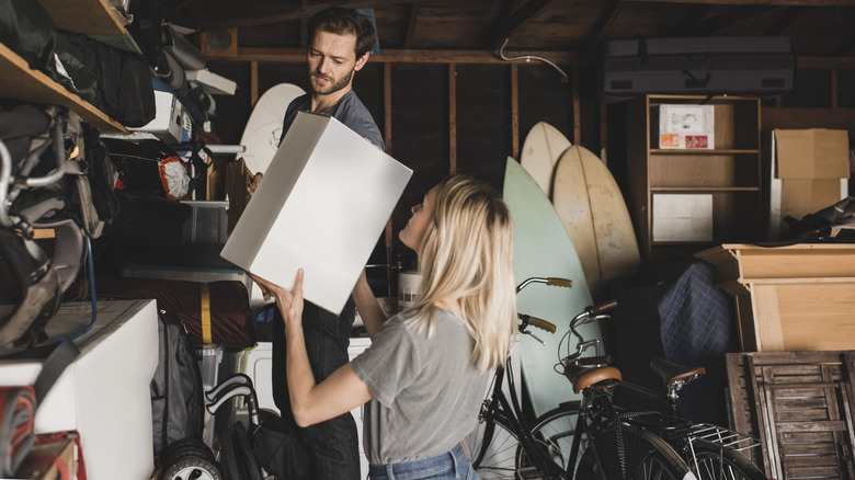 Couple working together to organize their garage
