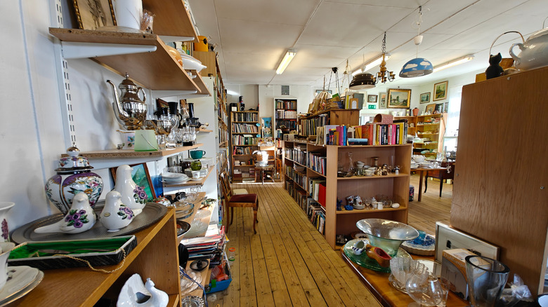 The interior of a thrift store with lots of items on display on shelves