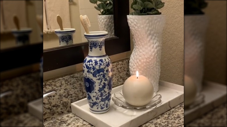 A blue and white floral vase used as toothbrush holder