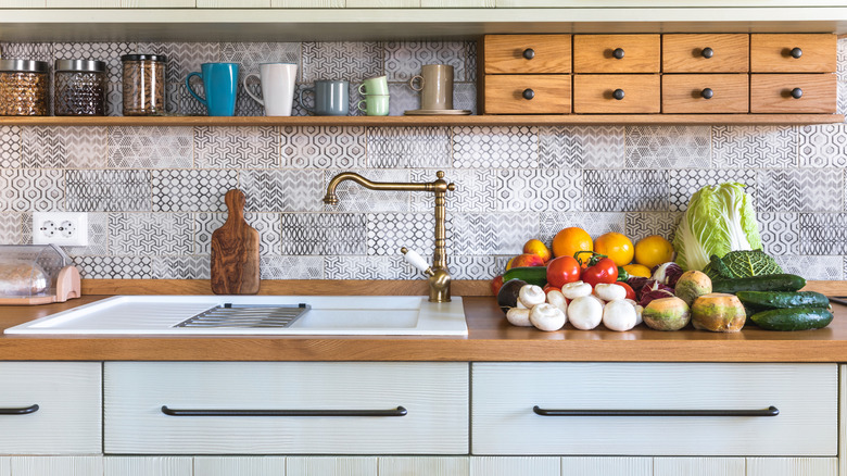 A kitchen design with different drawer styles