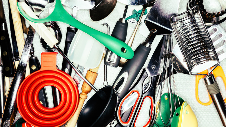 Random kitchen utensils cluttered in a drawer