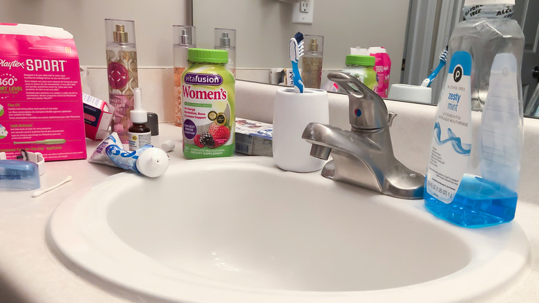 cluttered bathroom countertop