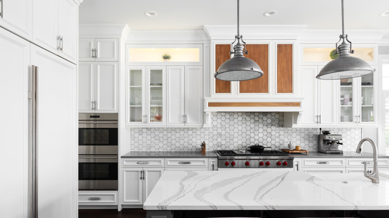 A white marble kitchen countertop, decluttered by removing the dish drying rack.