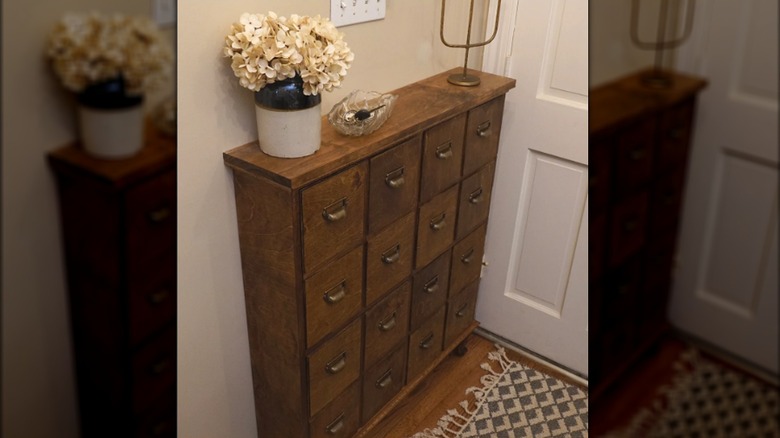 an apothecary shoe cabinet in a front entry