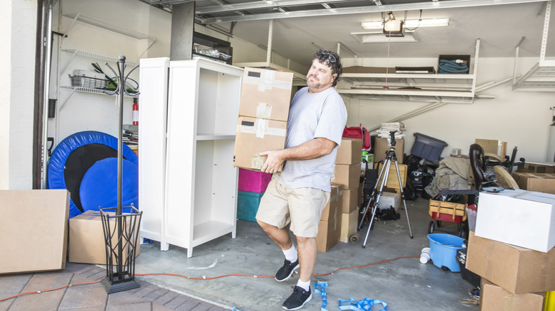 Man empties out his garage while doing the out-in-the-open method.