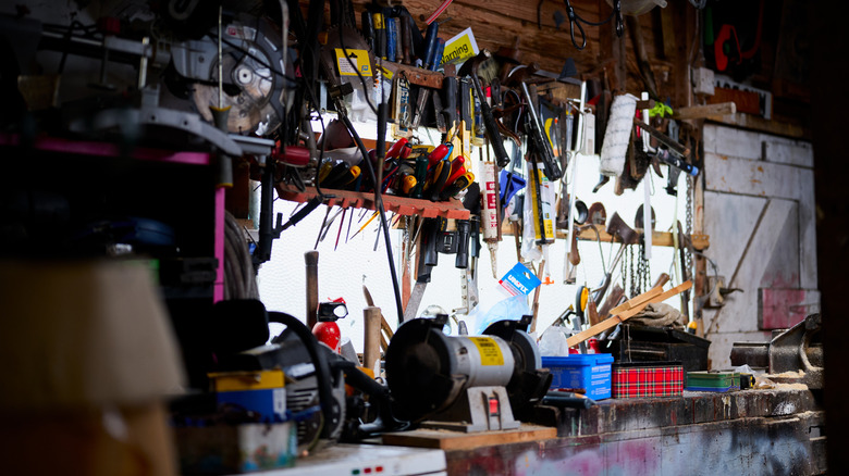 A very cluttered workbench with lots of tools