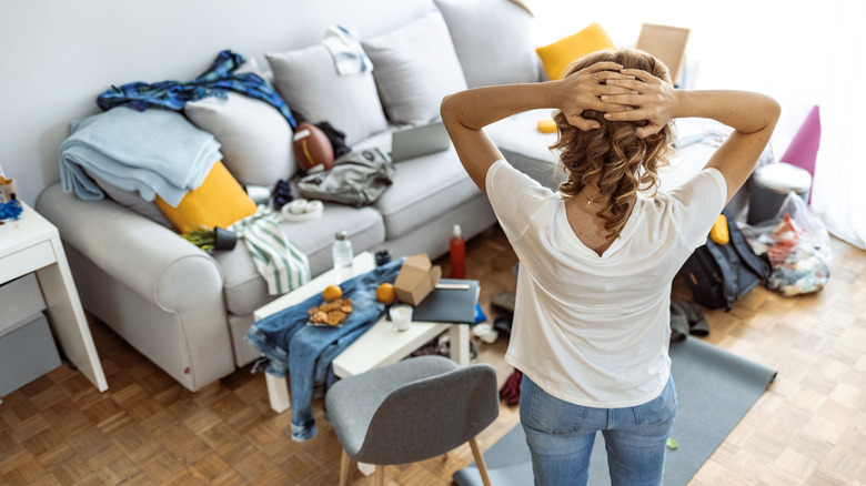 Person looking at cluttered room