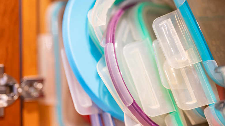 Assorted plastic lids in a cupboard
