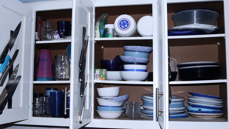A kitchen cupboard filled with clutter