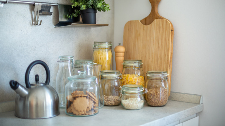 Jars of pasta and cereals sitting out on a counter