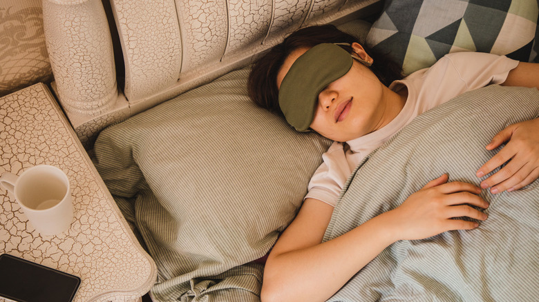 Young woman wearing an eye mask and sleeping peacefully