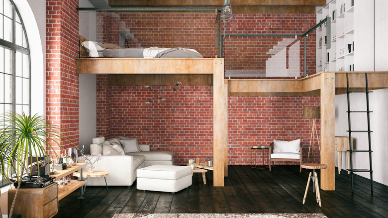 fully furnished and decorated studio apartment with loft bedroom and exposed brick wall