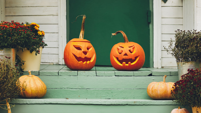 Jack o' lantern pumpkins on stoop